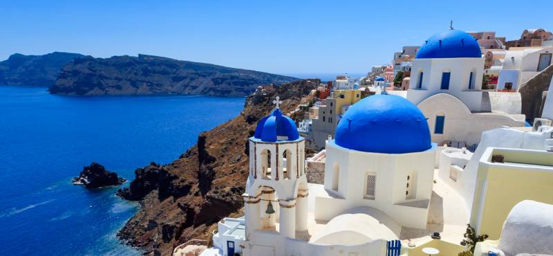 The blue-domed and white washed houses of Santorini island in Greece